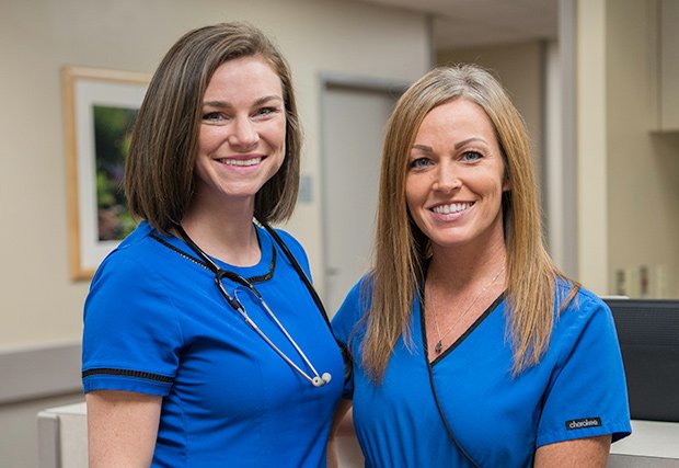 Two female nurses smiling